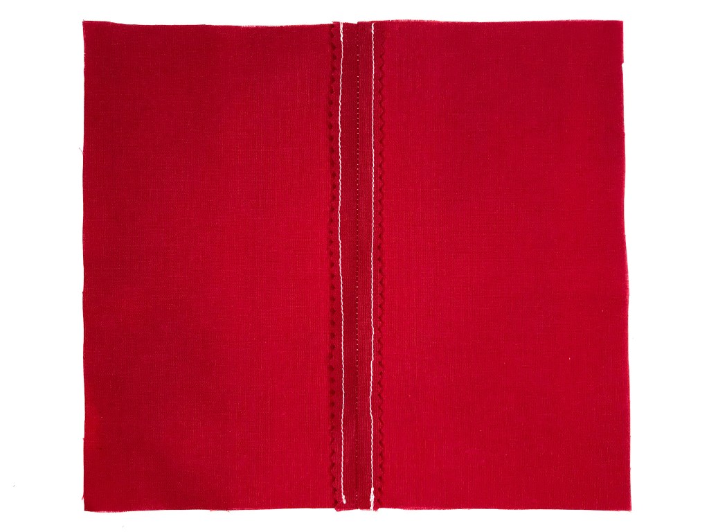 Fabric pieces with stitching and pinking sewn together and seams pressed open.