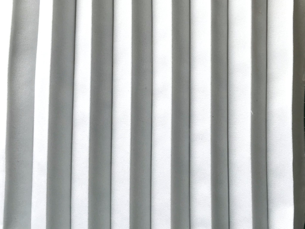 Permanently pleated duchess satin fabric. Permanent accordion pleats.