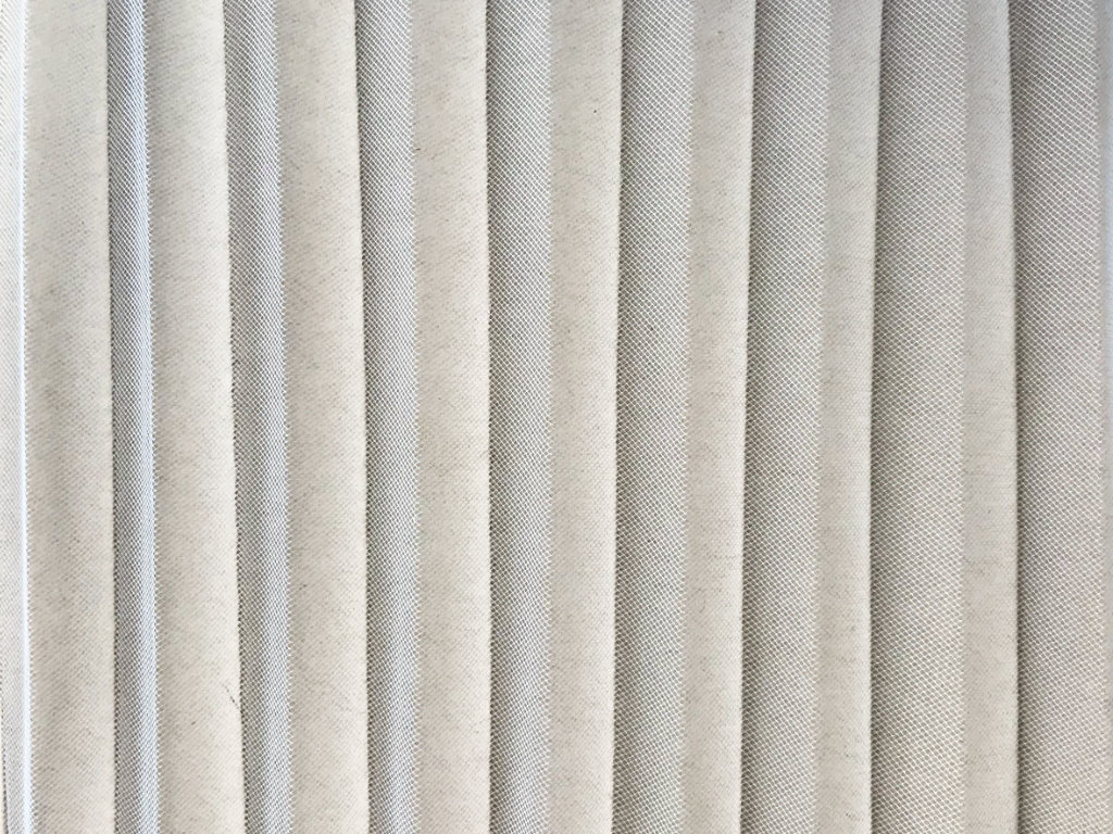 Permanently pleated tulle mesh. Accordion pleats.