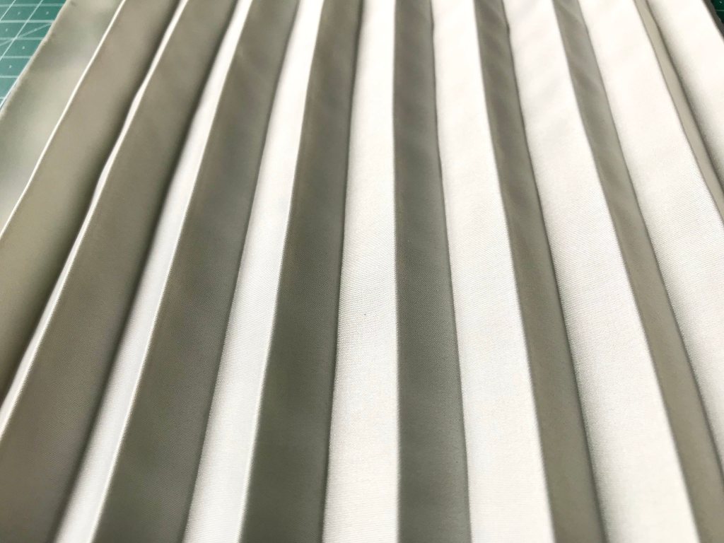 Hand pleated micro satin fabric after being wrinkled and washed.
