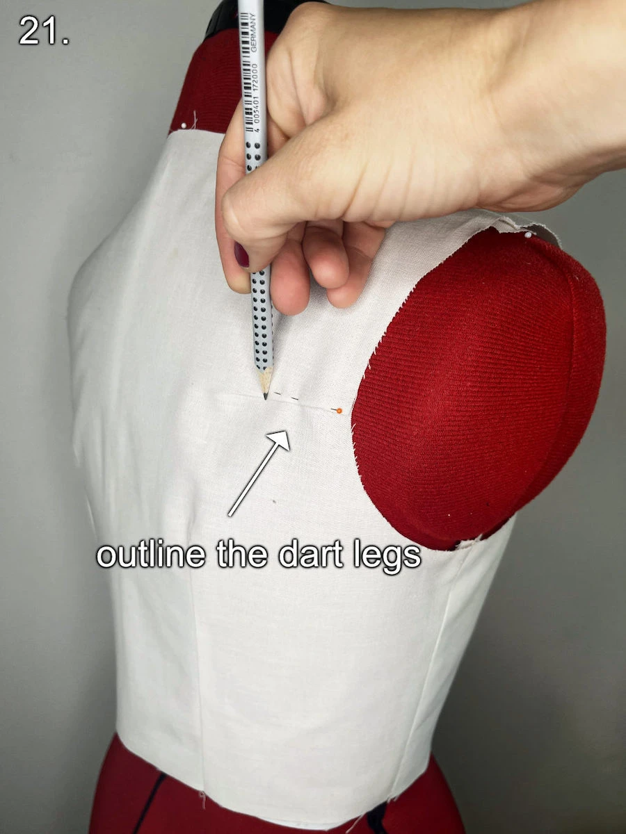 Outlining the folded dart at the basic bodice back pattern piece with a pencil.