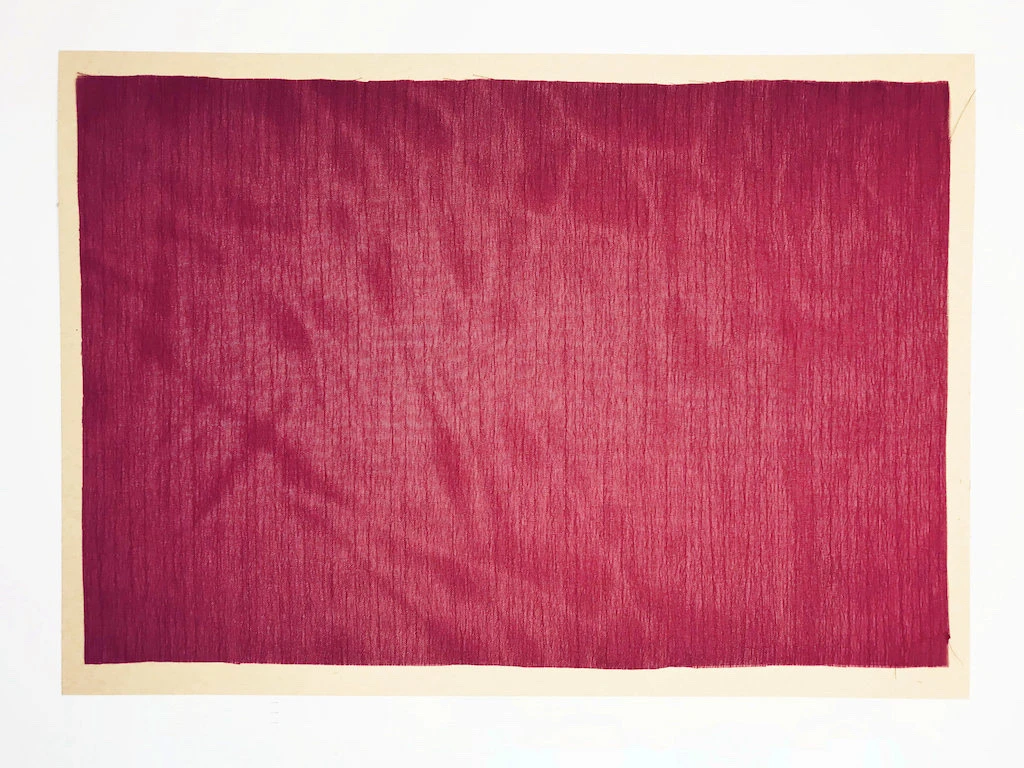 A piece of fabric placed on an A4 kraft paper.