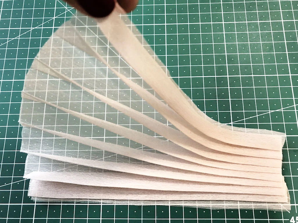 Pleated pink chiffon fabric. Knife pleats.