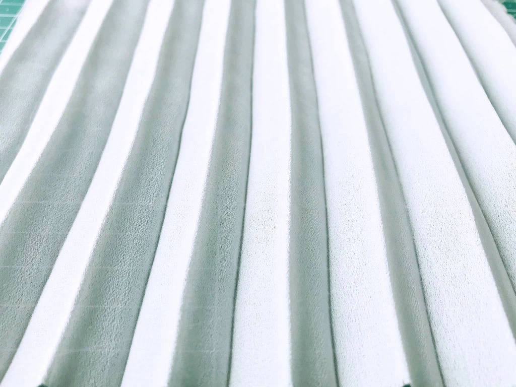 Creased permanently pleated georgette fabric. Permanent accordion pleats.