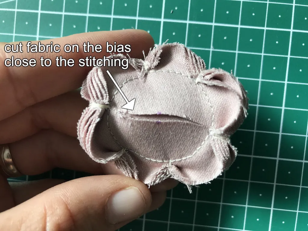 Cut in the middle of the fabric on the bias.