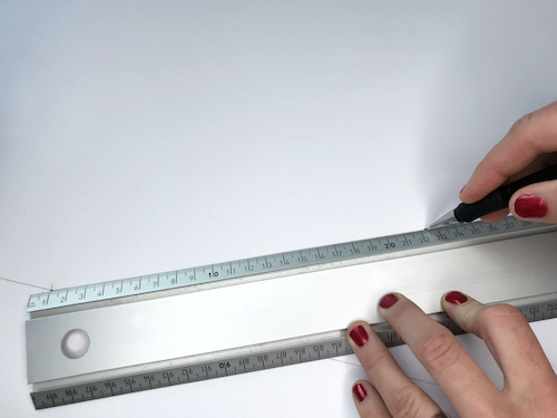 Drawing the side seam of a circle skirt with a long ruler.