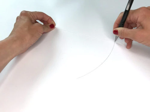 Drawing a full circle by pivoting a pencil around a pin.