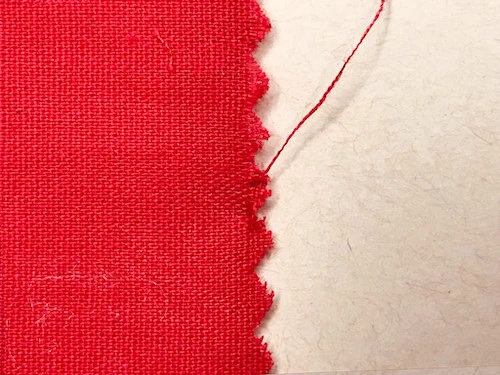Woven fabric cut with piking sheers on the length grain.