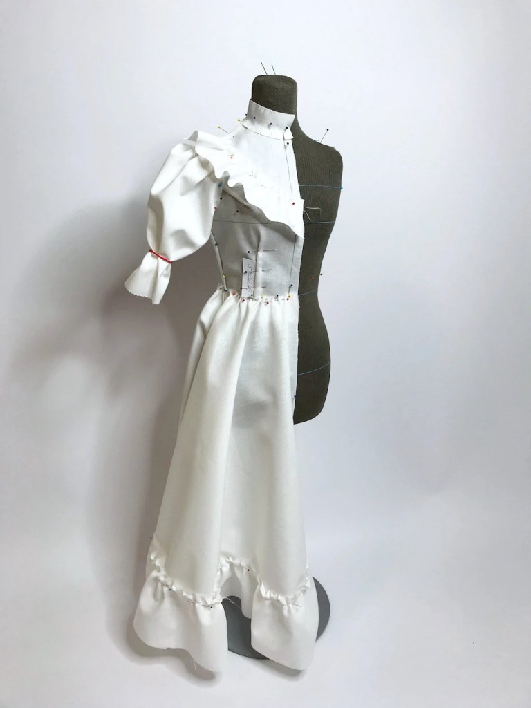 Draping a dress directly on a half-size tailors dummy.