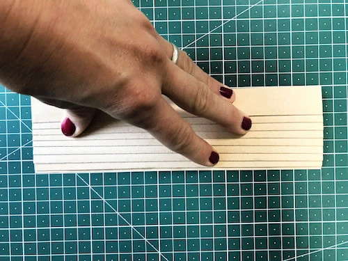 Measuring the size of fusible interfacing using a gird.