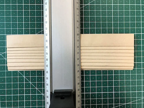 Measuring the size of fusible interfacing for permanent knife pleat moulds using a ruler.