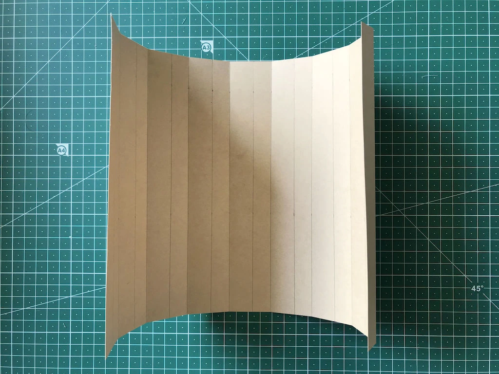 Partly folded kraft paper mould for permanent knife pleats.