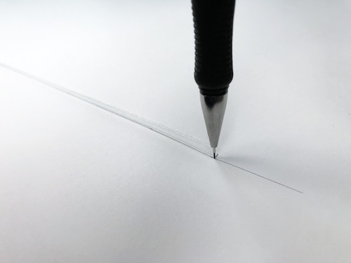 Drawing the hem of a circle skirt with a looped string and pencil.