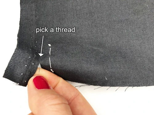 Picking a thread from the clipped area along the selvage line.