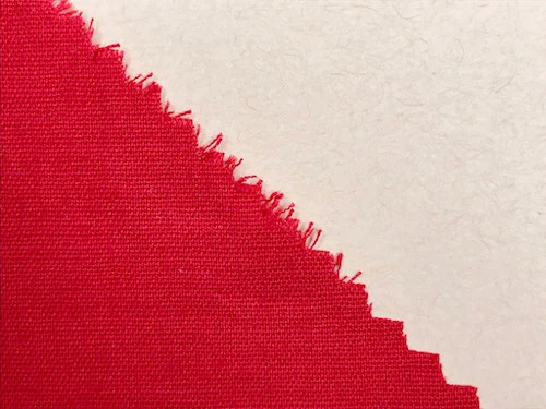 Woven fabric cut with piking sheers on the bias.