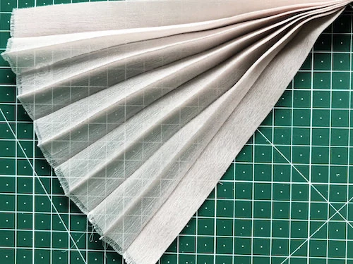 Permanently pleated chiffon fabric. Accordion pleats.