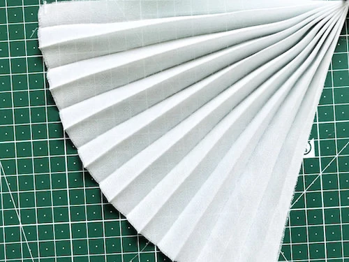 Permanently pleated georgette fabric. Permanent accordion pleats.