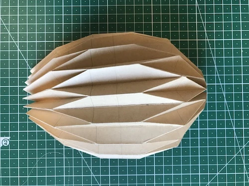 Bowl shaped hand pleated kraft paper.