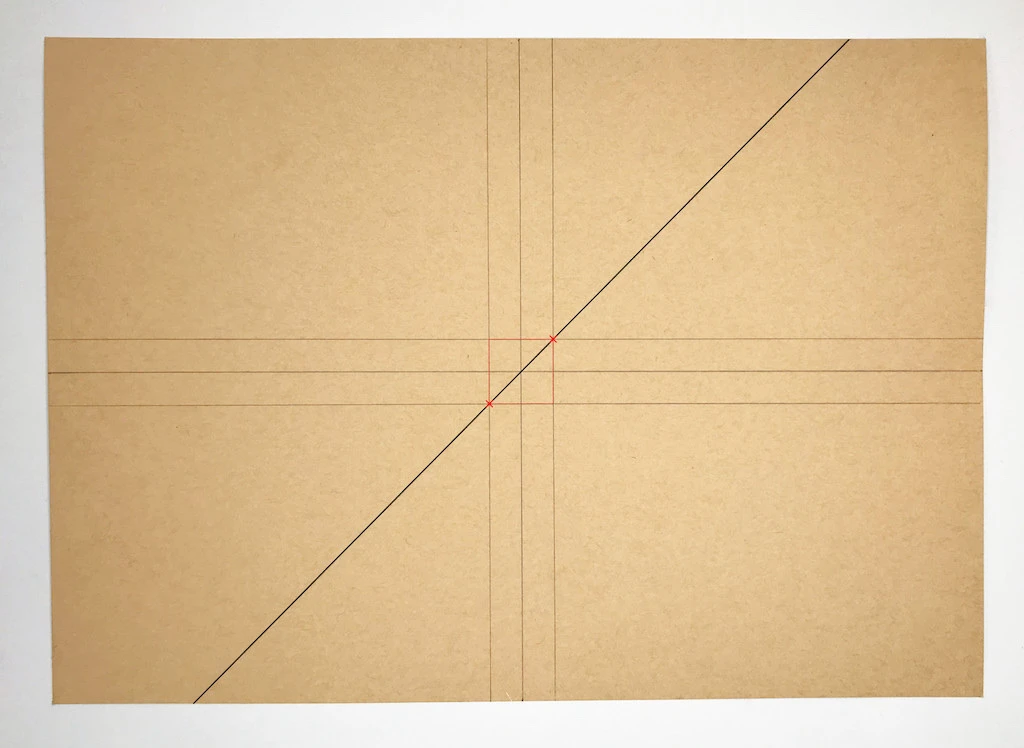 Drawing a diagonal line on kraft paper.