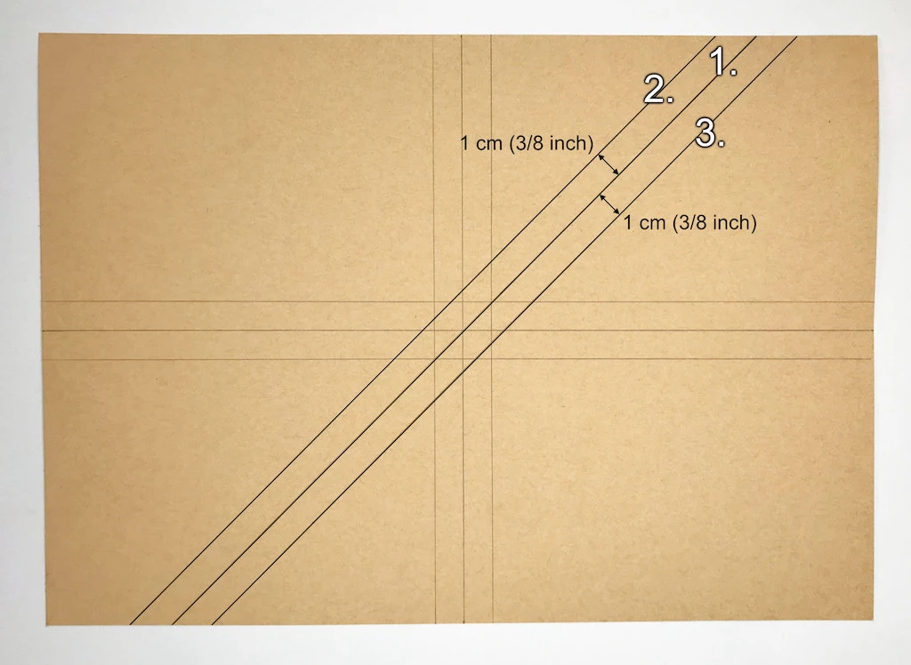 Drawing three diagonal lines on kraft paper.
