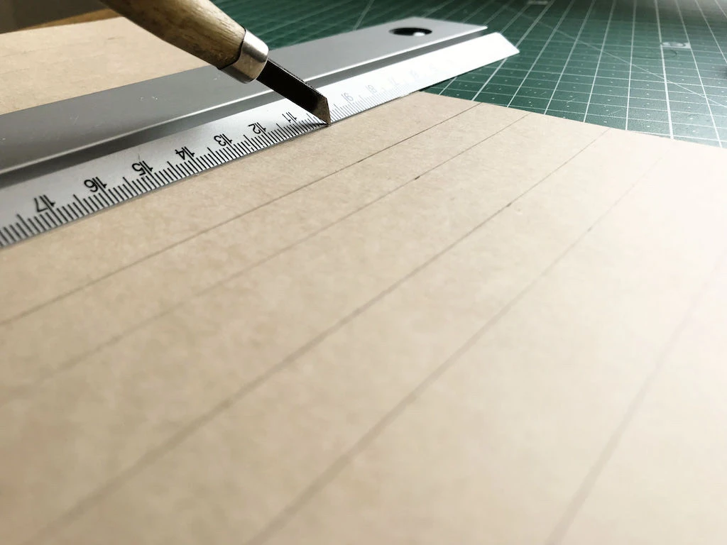 Pre-pressing knife pleating moulds with an art knife.