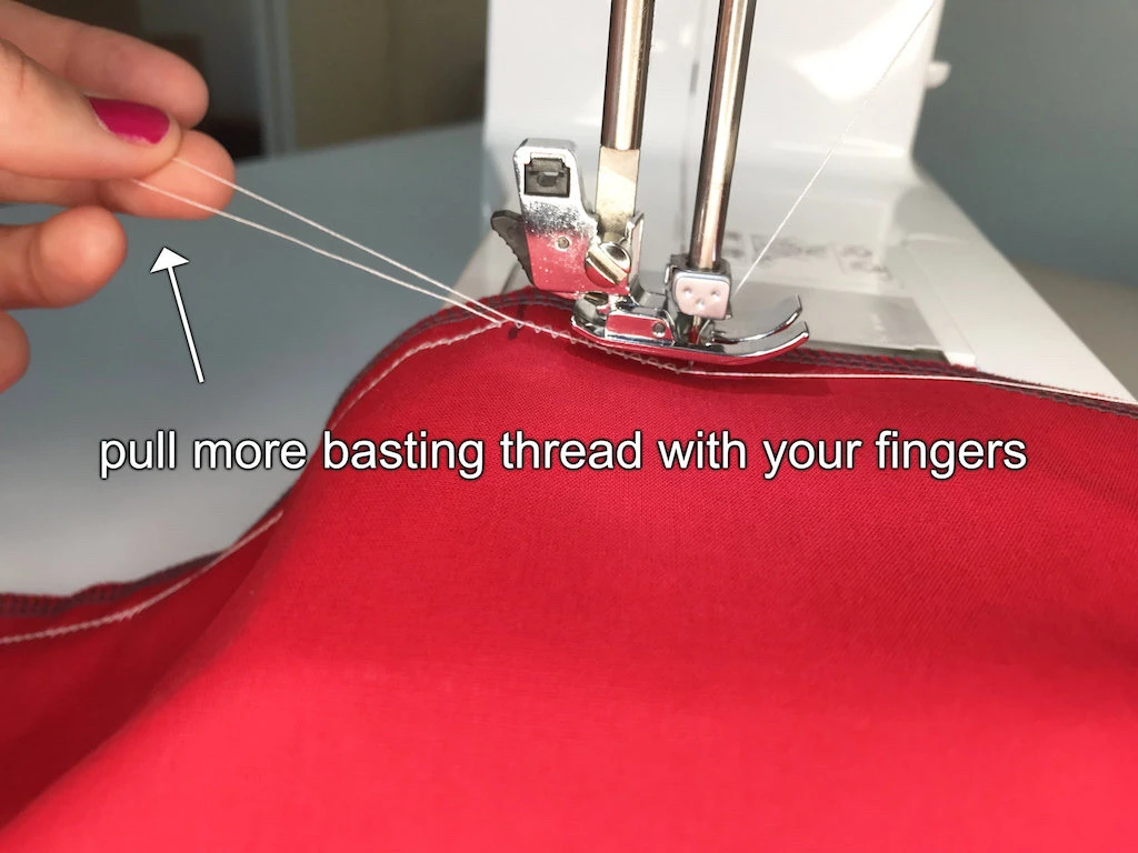 Pulling basting thread in the zig zag stitch with fingers.