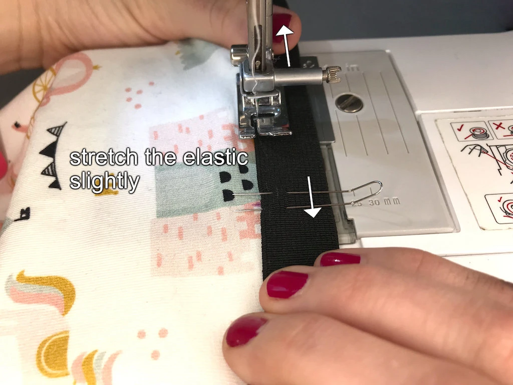 Sewing an elastic waistband to legging using a triple zig-zag stitch.
