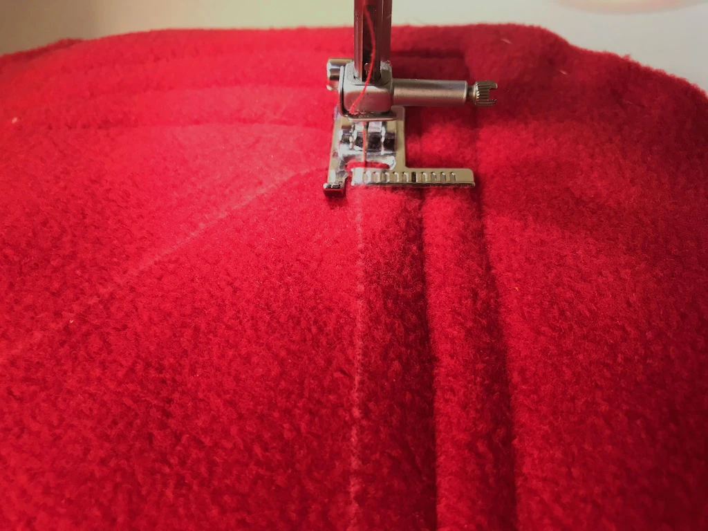 Sewing over a drawn diagonal line with a sewing machine.