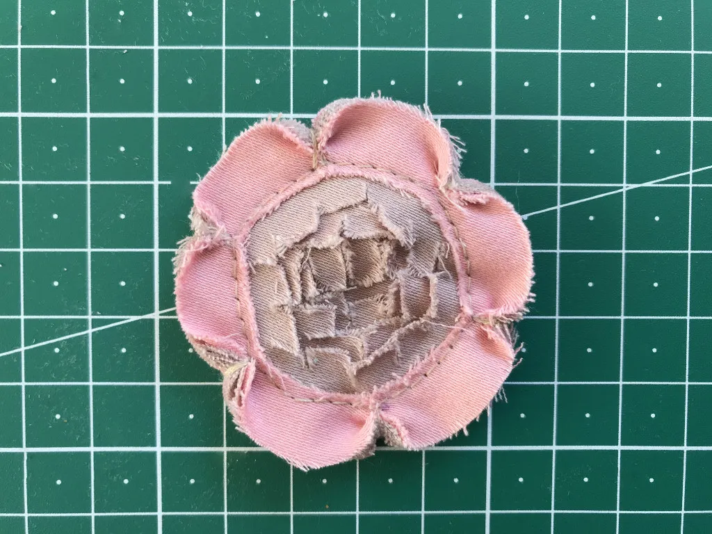 Small pink flower applique created by the stitch and slash fabric manipulation technique.