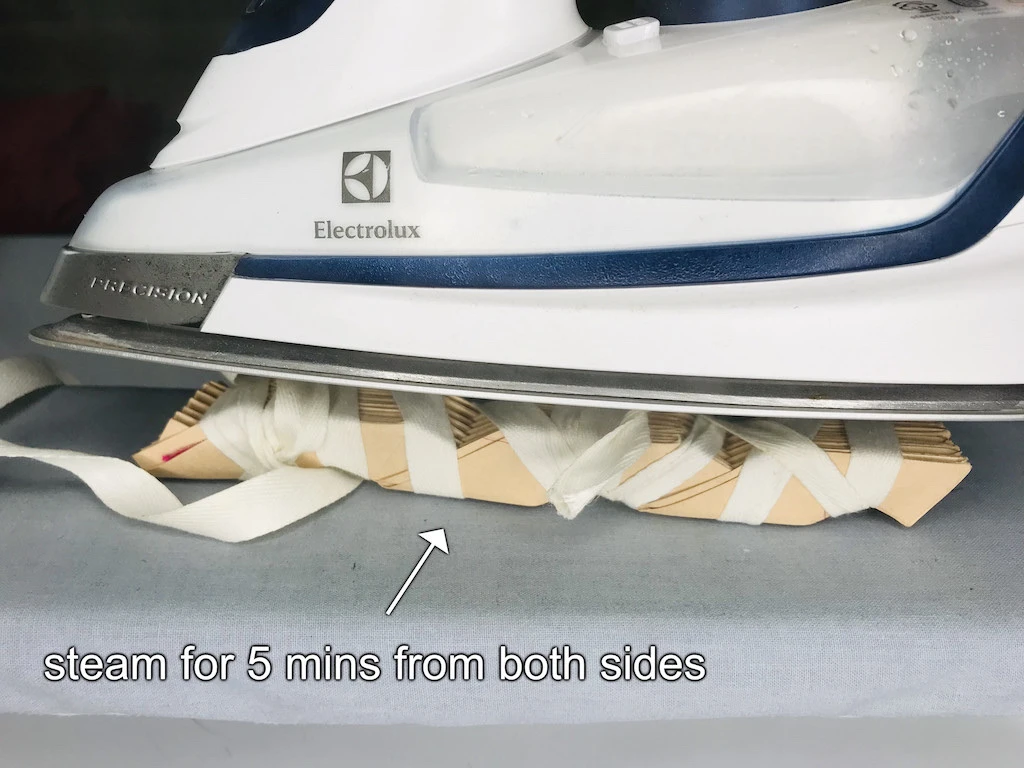 Steam the fabric in between pleating moulds. 5 minutes from each side.