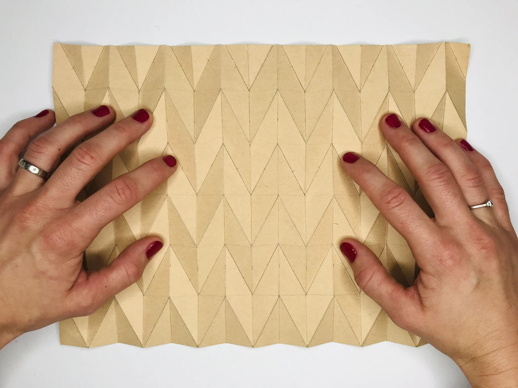 Preparing the pleating mould for fabric.