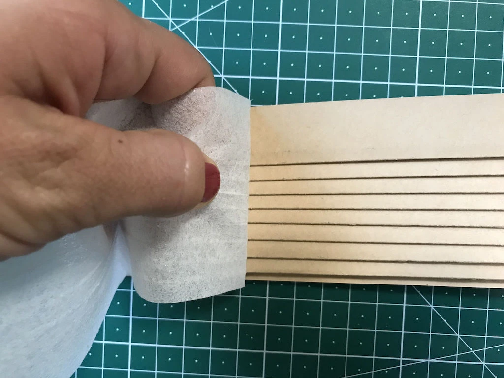 Tearing off the fusible interfacing from mould.