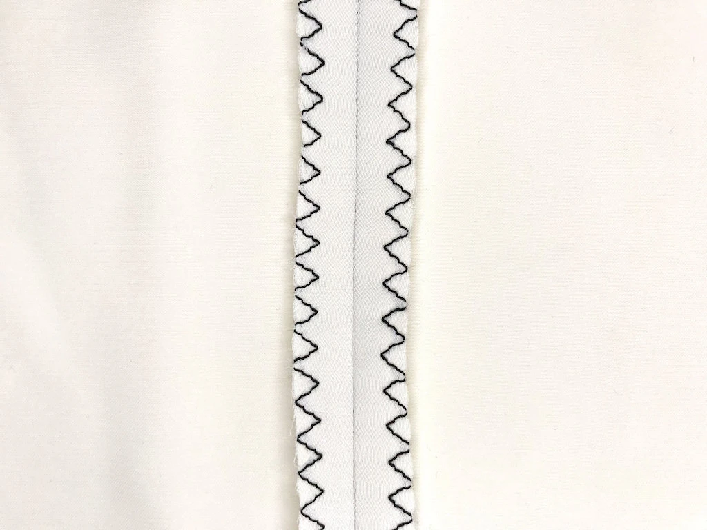 Three step zig-zag stitch seam finish on micro satin fabric.
