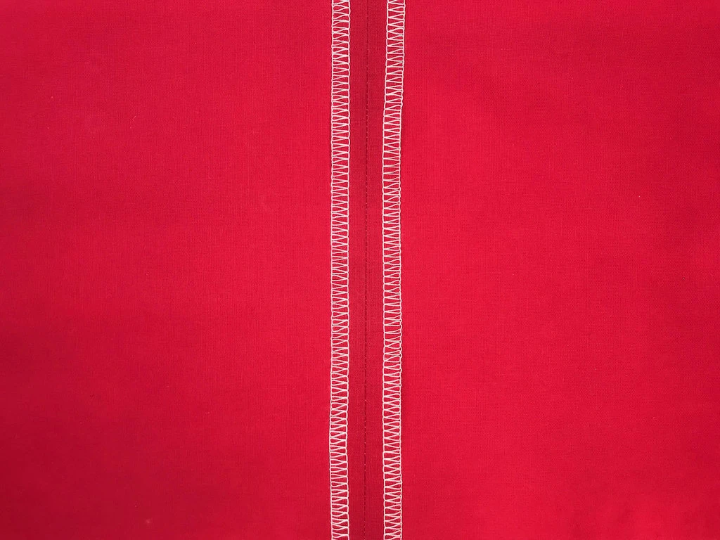 Three thread overlock seam made by an overlock machine.
