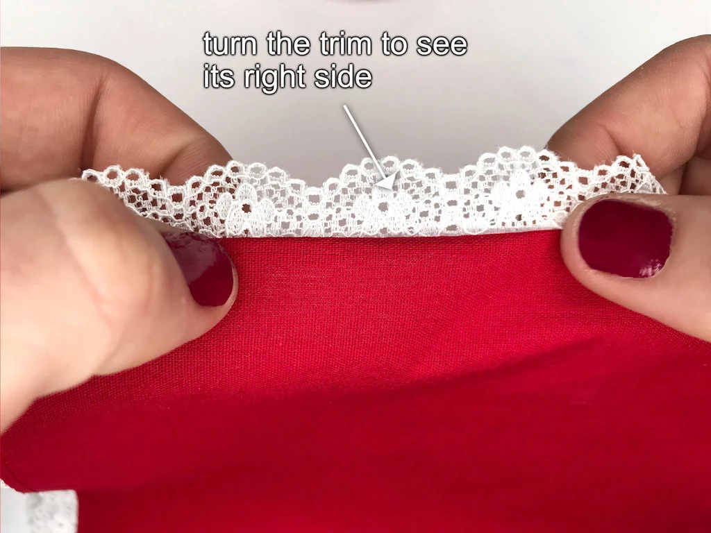 Folding a lace trim to its right side.