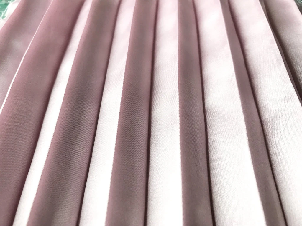 Hand pleated satin fabric after being wrinkled and washed.