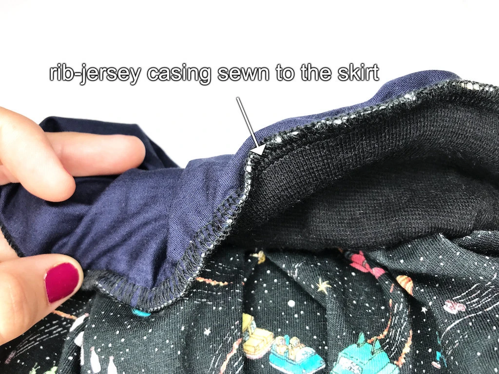 All layers (waistband casing, lining, skirt) sewn together at waist.