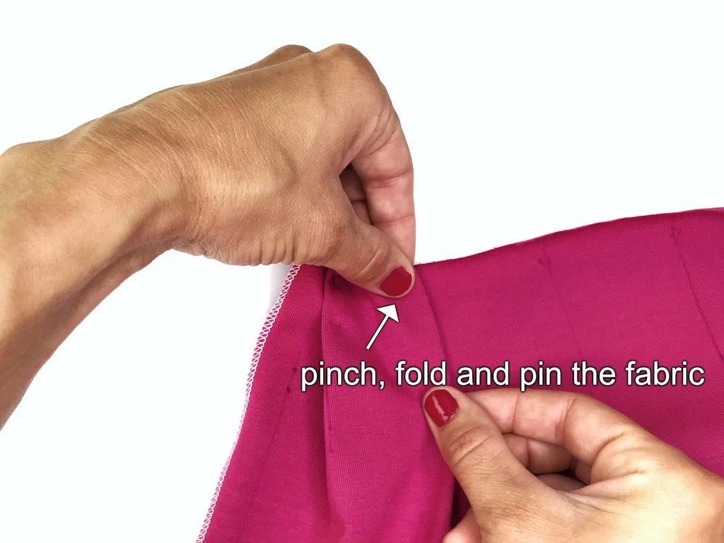 Folding fabric to create a box pleat.