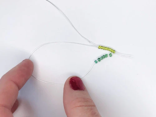 Looping two wires through one line of beads.