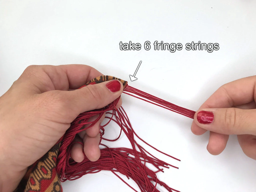 Finishing a Sybill Trelawney headband by grouping fringe strings into chunks.