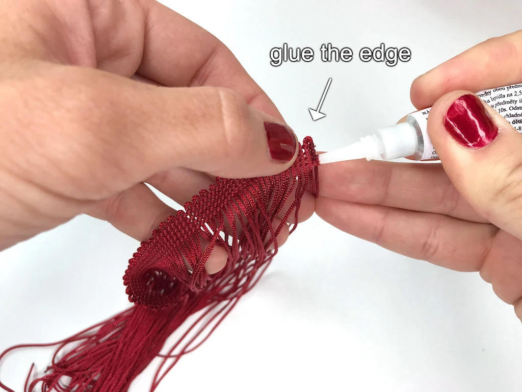 Glueing edges of fringe trims.
