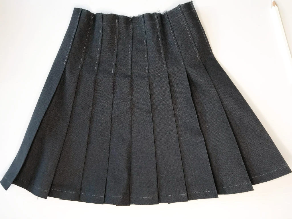 Grey skirt with knife pleats.