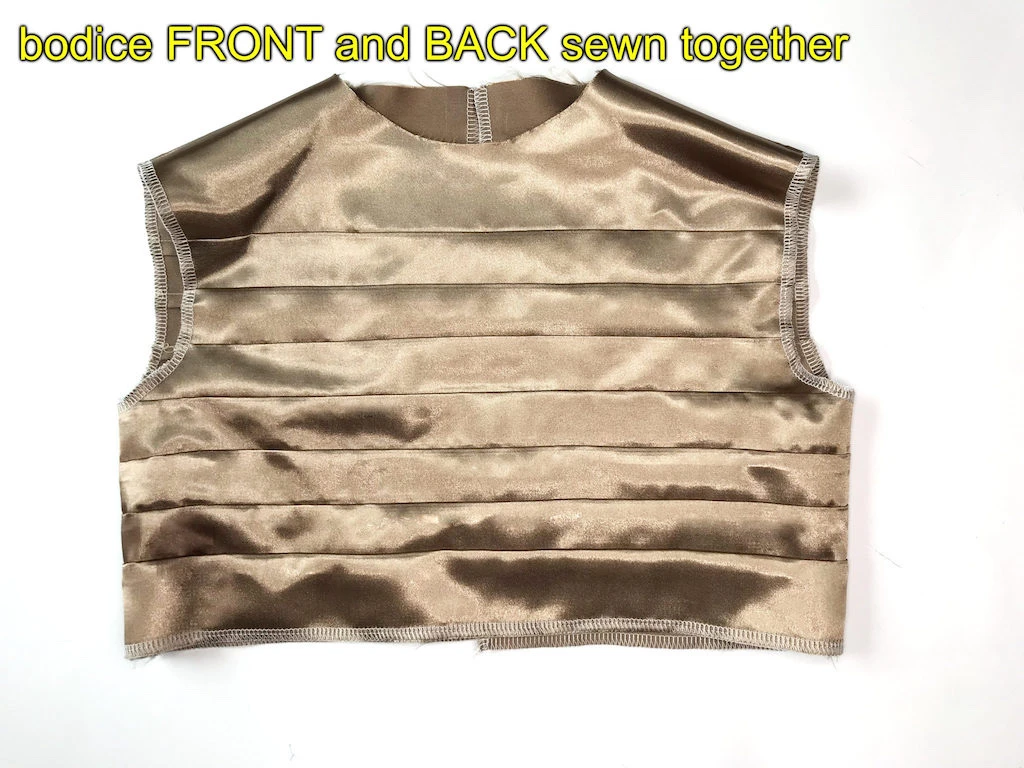 Bodice front and back pattern pieces sewn together with seam allowance pressed open.