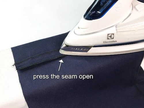 Pressing a lining fabric side seam open.