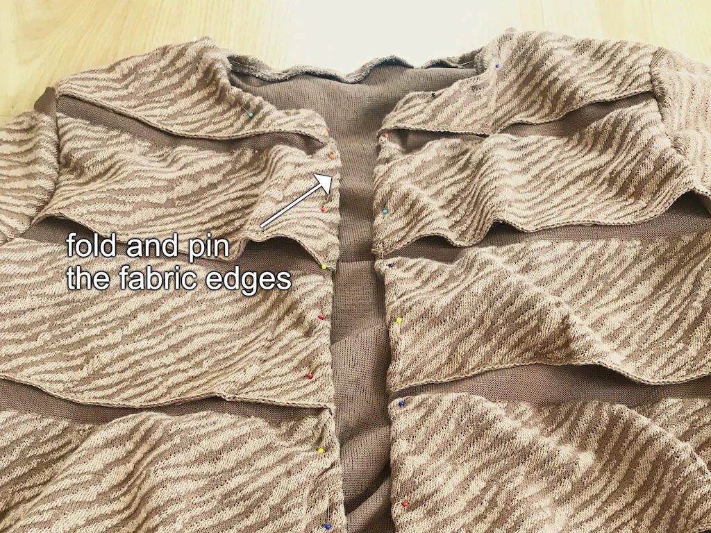 Folded fabric edge of the sweater.