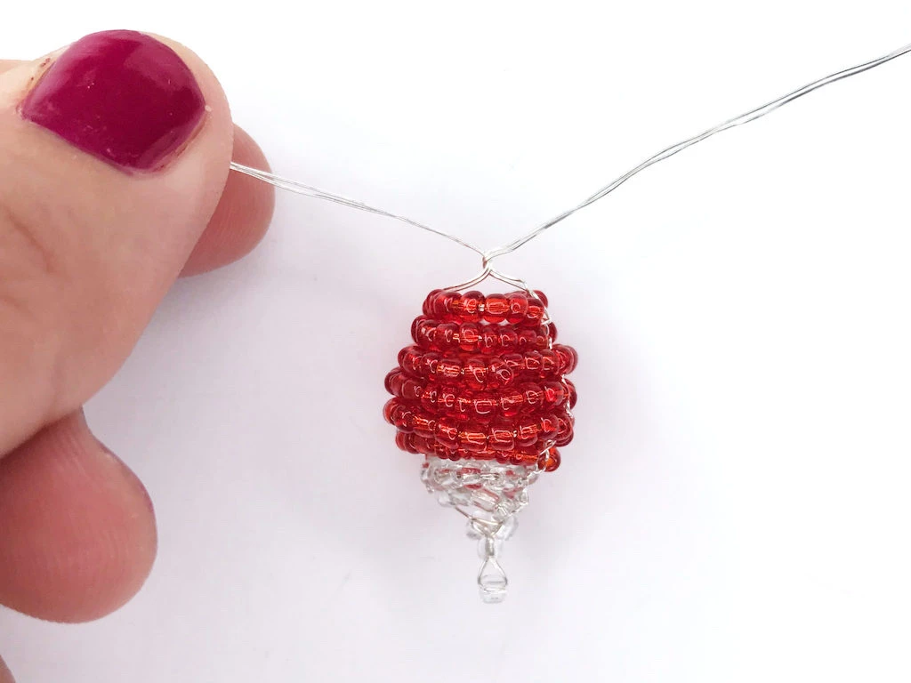 Twisting wires on a radish made of beads.