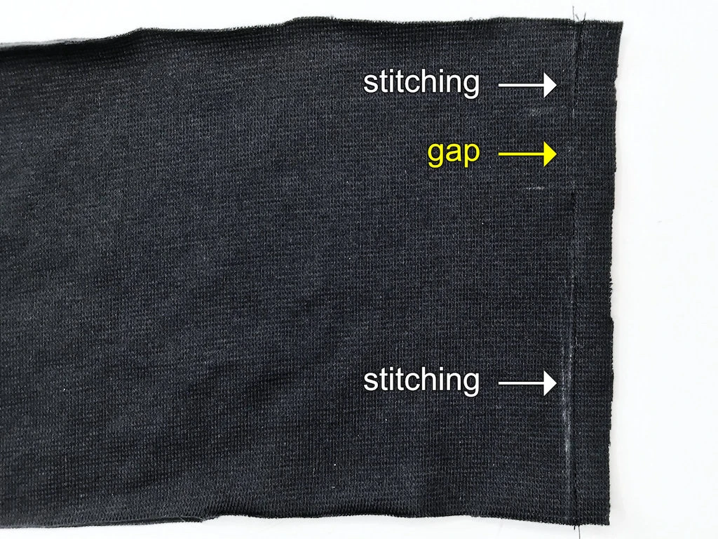 Sewn seam on a rib jersey elastic waistband casing.